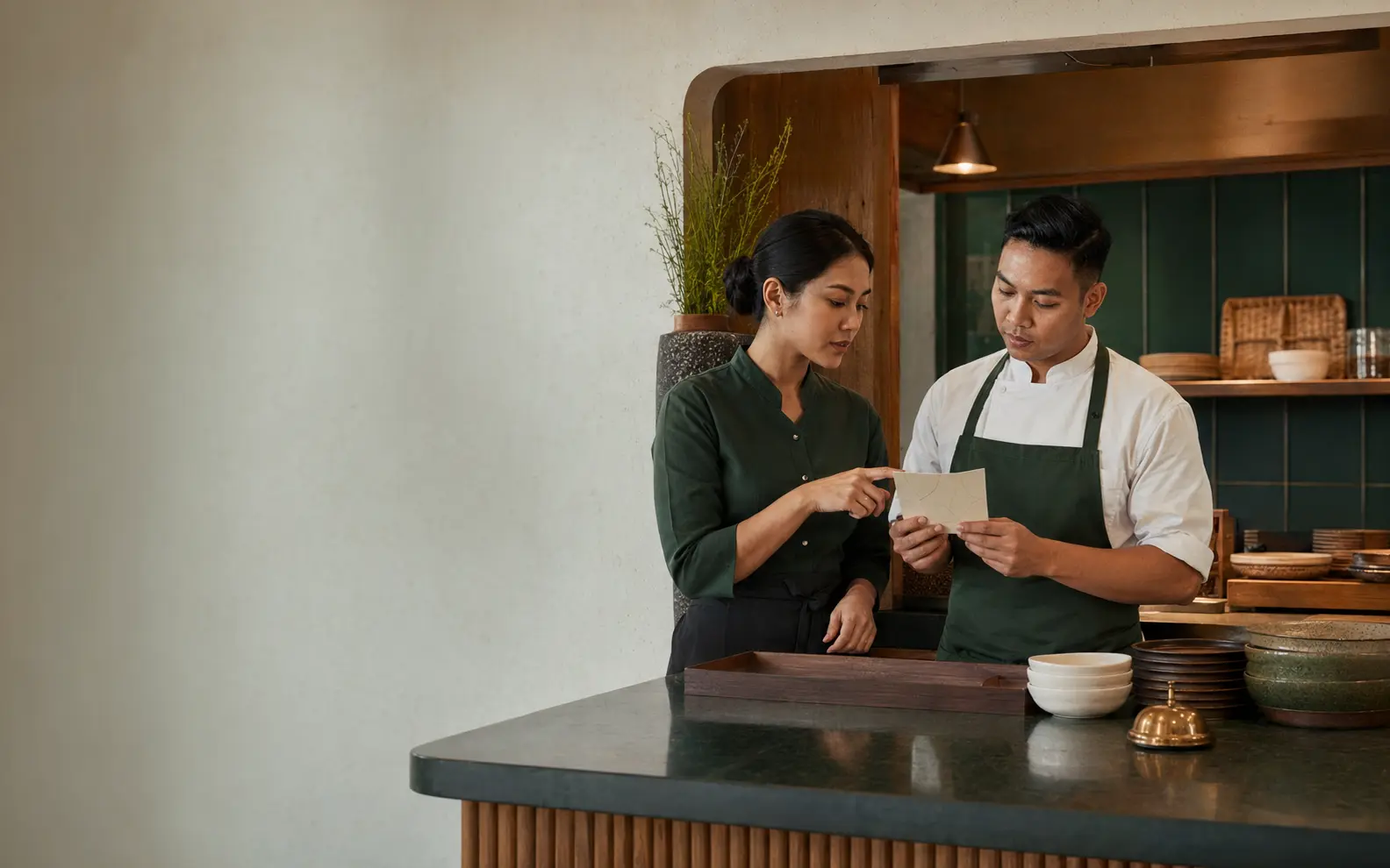 Professional hospitality staff serving a restaurant guest
